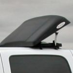 White SUV with a black rooftop cargo hatch raised on top of the vehicle.